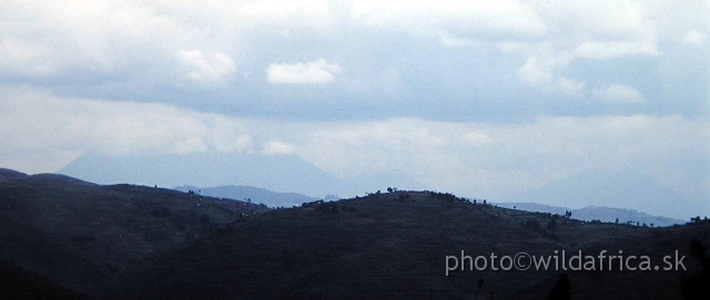 PA170066.JPG - Virunga volcanoes in the clouds, the silhoutte of symmetrical Muhavura is visible.